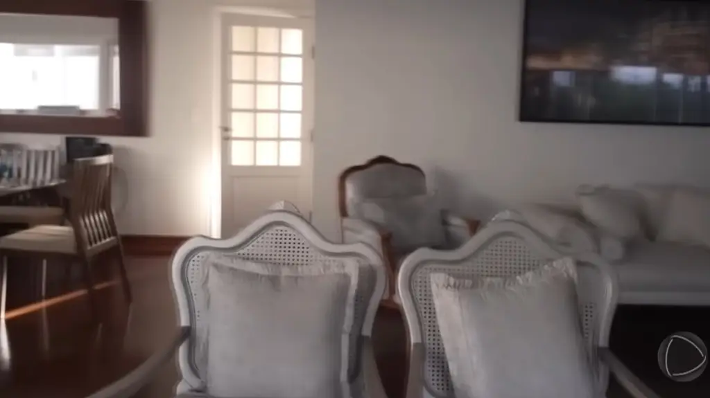 Sala de estar da casa de Reinaldo Gottino com móveis em tons neutros